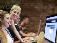 Students looking at laptop reversed